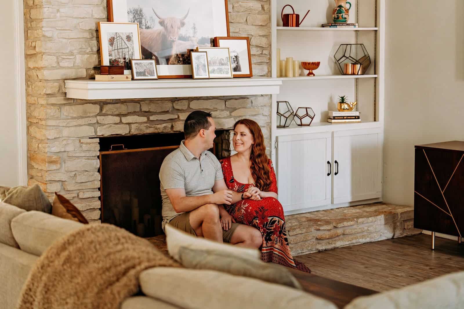 A couple posing for photos in their Austin home before their move