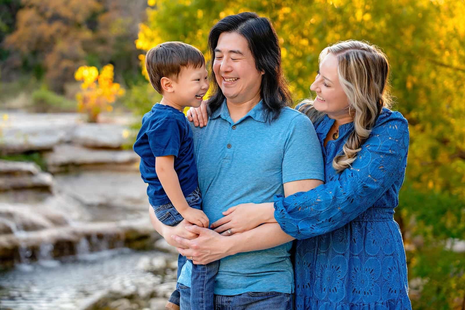Vibrant fall foliage with a happy family enjoying outdoors.
